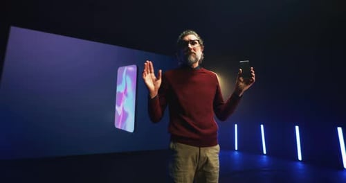 Middle Aged Speaker Explaining Smartphone Features