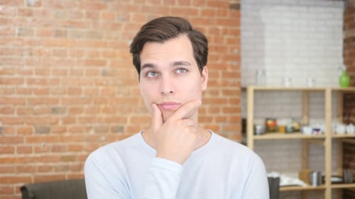 Thinking Young Man at Workplace
