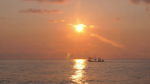 Fishing Boat With Fisherman Sailing At Sunset In Sea.