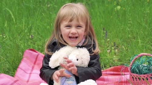Little Girl With Soft Toy Smiling On a Camera.