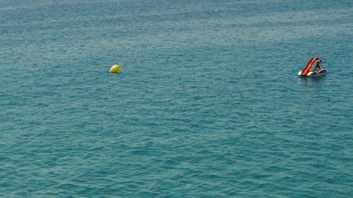 Group Of Young People Ride Catamaran In Sea At Summer Sunny Day