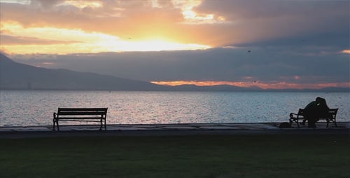Lovely Couple Sitting On The Beach