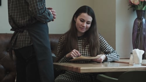 Woman Makeing Order In Cafe
