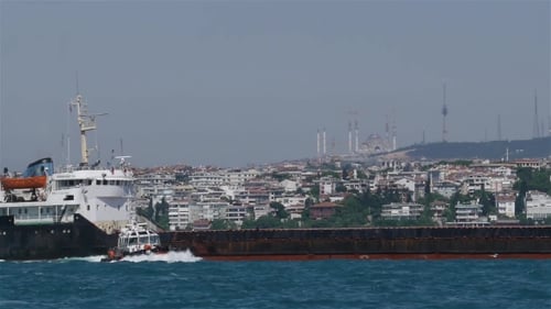 Pilot Boat Approaching Container Ship near City