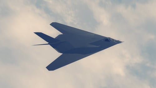 F-117 Nighthawk Stealth Fighter Jet Flying in Cloudy Sky