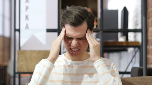 Stressed Man with Pain in Head