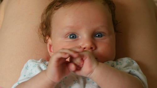 Cute Infant Lying on Back Looking Around