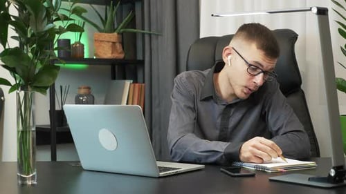 Young Adult Engaging in Video Call in Home Office