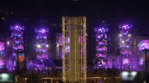Illuminated Stage and Energetic Crowd at Music Festival