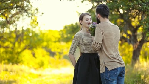 Young Couple Shares Loving Moment with Wildflowers