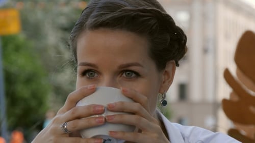 Young Beautiful Woman Holding Cup of Coffee at Bar