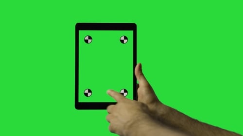 Die Hand des Mannes gleitet auf dem grünen Bildschirm des Tablets