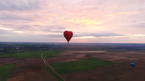 Hot Air Balloon In The Sky Over a field.Aerial View