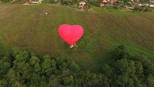 Hot Air Balloon In The Sky Over a field.Aerial View