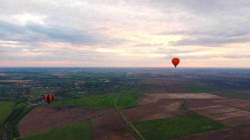 Hot Air Balloons In The Sky Over a field.Aerial View