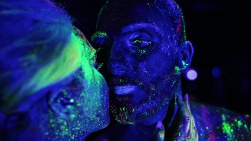 Couple In Love Painted Fluorescent Powder Kiss Under Ultraviolet Light.