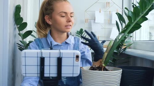 Woman with Plant Vlogging Indoors