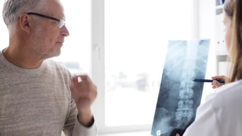 Doctor Showing X-ray To Senior Man At Clinic 75