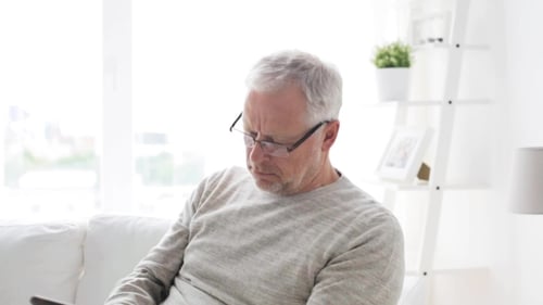 Man Uses Tablet in Bright Home Setting