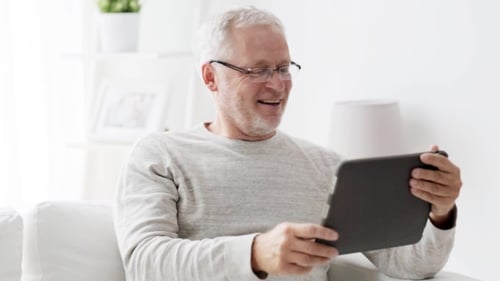 Senior Man Video Calling on Tablet at Home