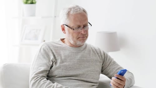 Senior Man Talking on Phone Indoors