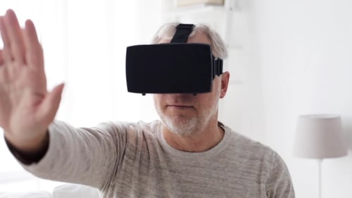 Senior Man Using Virtual Reality Headset at Home