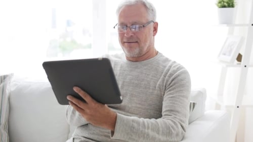 Senior Man Using Tablet at Home