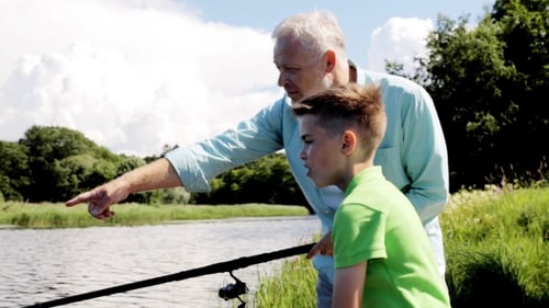 Grandfather And Grandson Fishing On River Berth 3