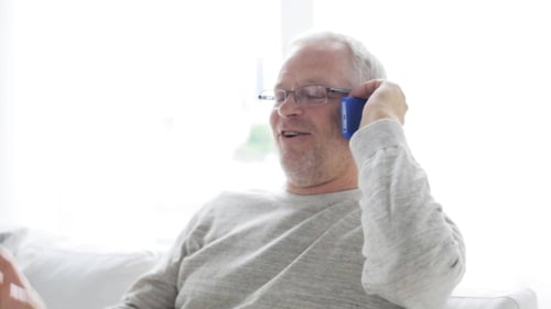 Senior Man Talking on Cellphone at Home