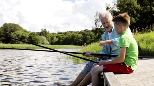 Grandfather And Grandson Fishing On River Berth 17