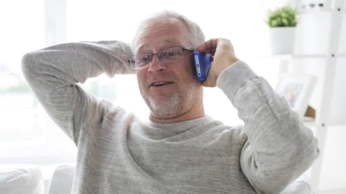 Man Talking on Phone Indoors, Smiling
