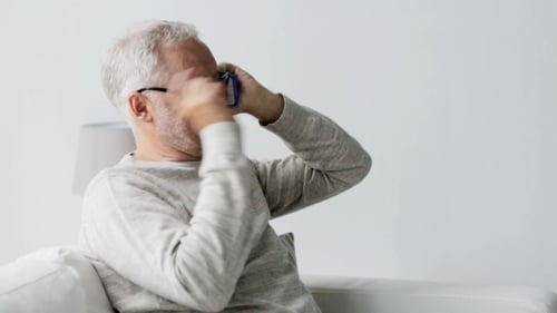 Senior Man Talking on Cell Phone Indoors