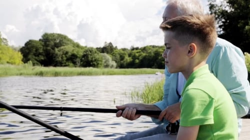Grandfather And Grandson Fishing On River Berth 10