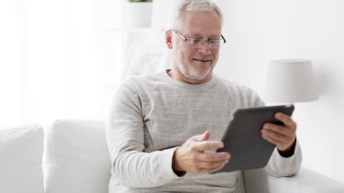 Senior Man Using Tablet at Home