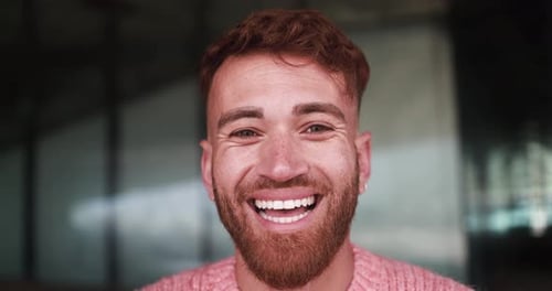 Young happy man smiling on camera outdoor
