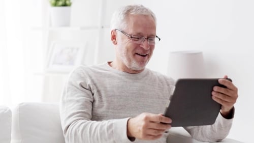 Man Relaxing at Home with Tablet