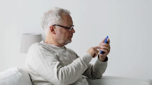 Senior Man Talking on Phone Indoors