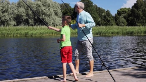 Grandfather And Grandson Fishing On River Berth 2