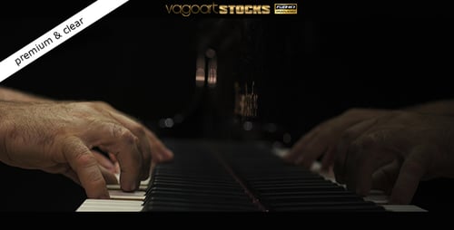 Hands Play Piano Keys in Dramatic Close-up