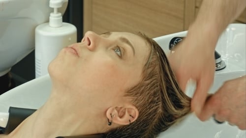Woman Having Hair Washed at a Salon Washbasin