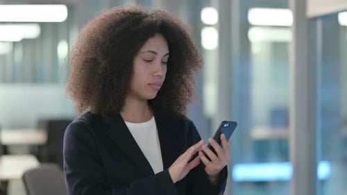 Portrait of African Businesswoman Scrolling on Smartphone