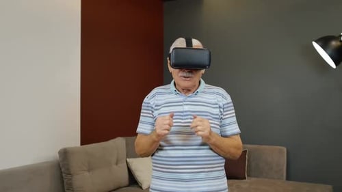 Senior Man Experiencing Virtual Reality With Headset