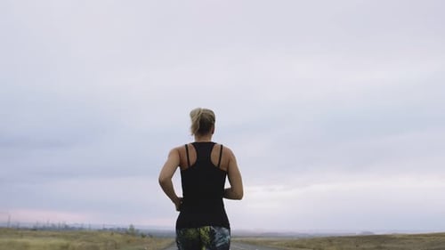 Woman in Sportswear Takes Day Run Outdoors Background Cloudy Sky Back View
