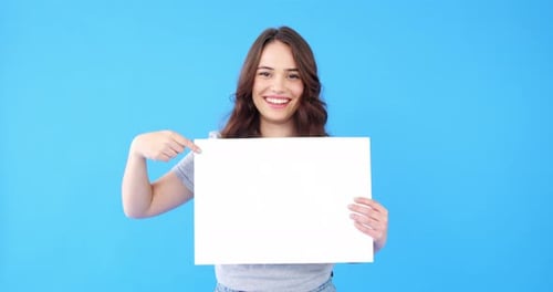 Woman Holding a Blank Sign with Solid Blue Background