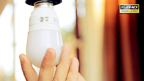 Hand Installing New LED Light Bulb in Socket