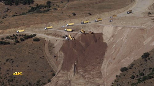 Excavation Trucks Transporting Materials in Rural Mine