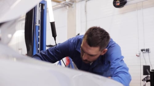 Mechanic Man Repairing Car At Workshop 21