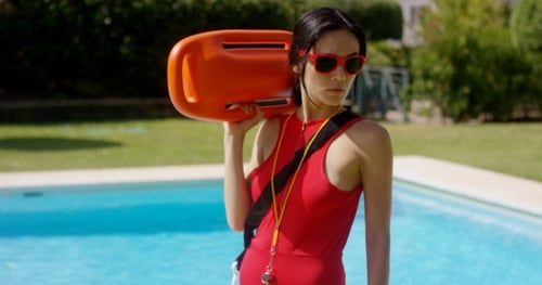 Lifeguard Woman Holding Buoy Standing Next to Pool