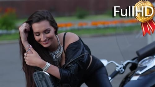 Fashionable Woman Leans on Motorcycle in City