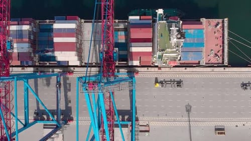 Drone Flying Over a Container Ship During Cargo Operations Over the Customs Area